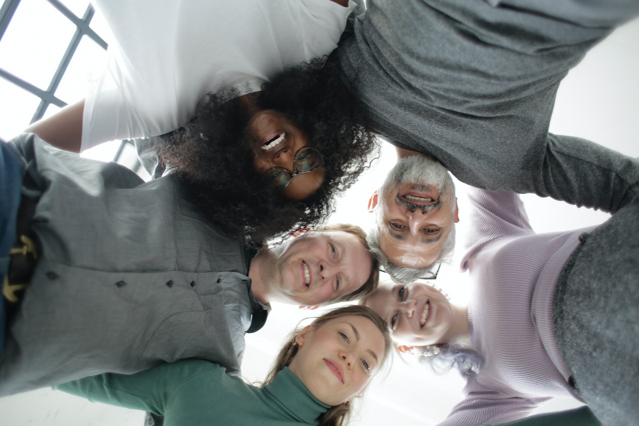 https://leadingthefuture.co/wp-content/uploads/2024/12/from-below-of-cheerful-multiethnic-coworkers-embracing-each-3931556.jpg